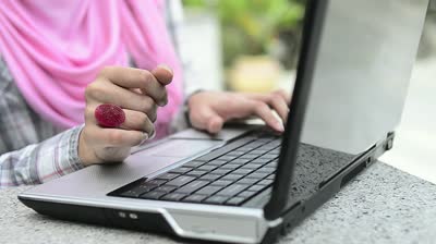 stock-footage-closeup-of-a-young-muslim-women-using-laptop